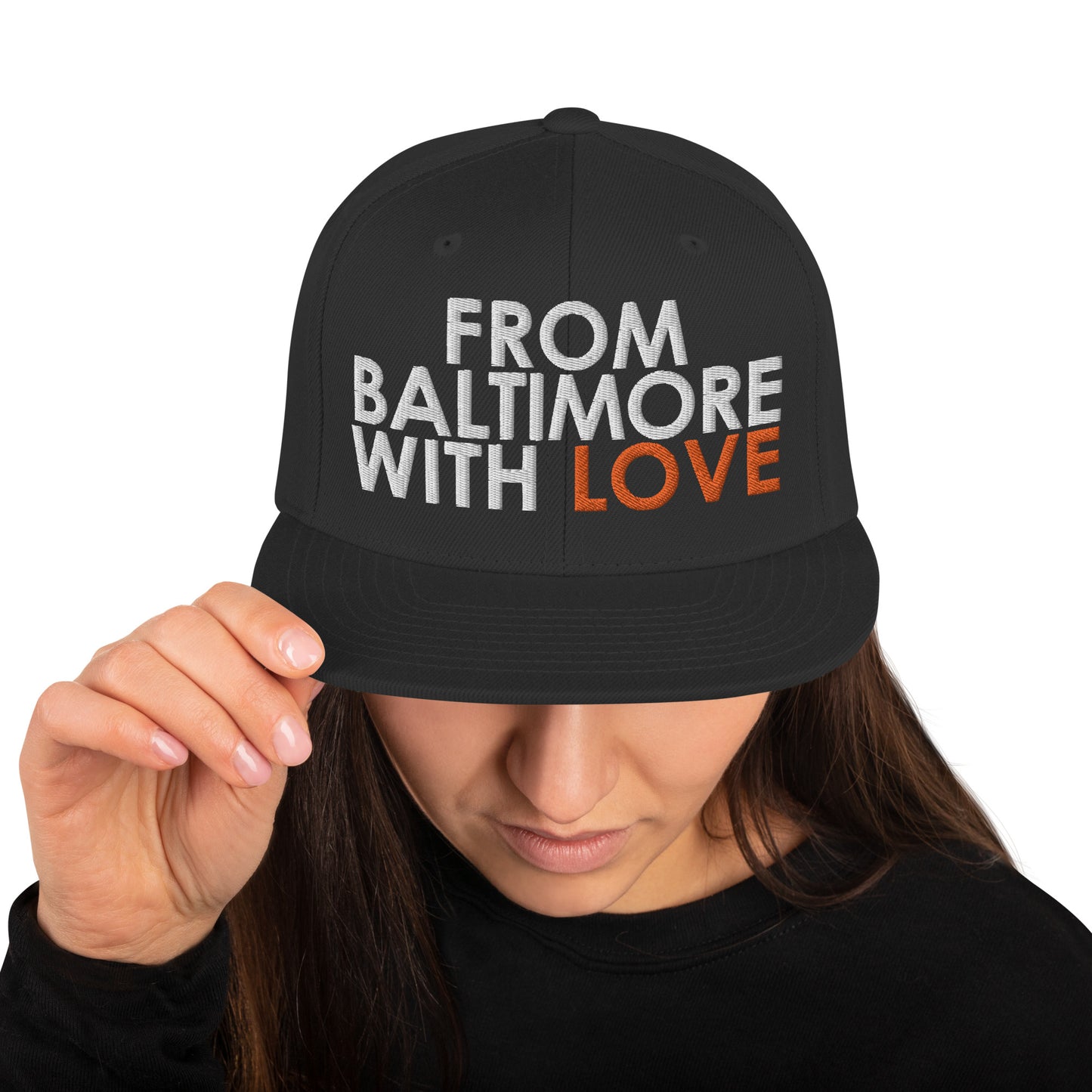 Black and orange Baltimore-inspired snapback hat from From Baltimore With Love™ featuring a classic adjustable design.