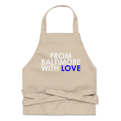 Blue cotton apron from Baltimore With Love™ featuring adjustable straps and a front pocket for cooking or baking.