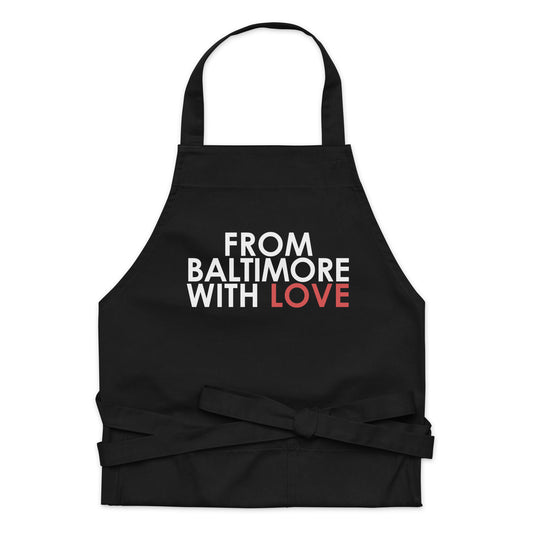 Red cotton apron from Baltimore With Love™ with classic design, featuring adjustable neck straps and front pockets for cooking or baking.