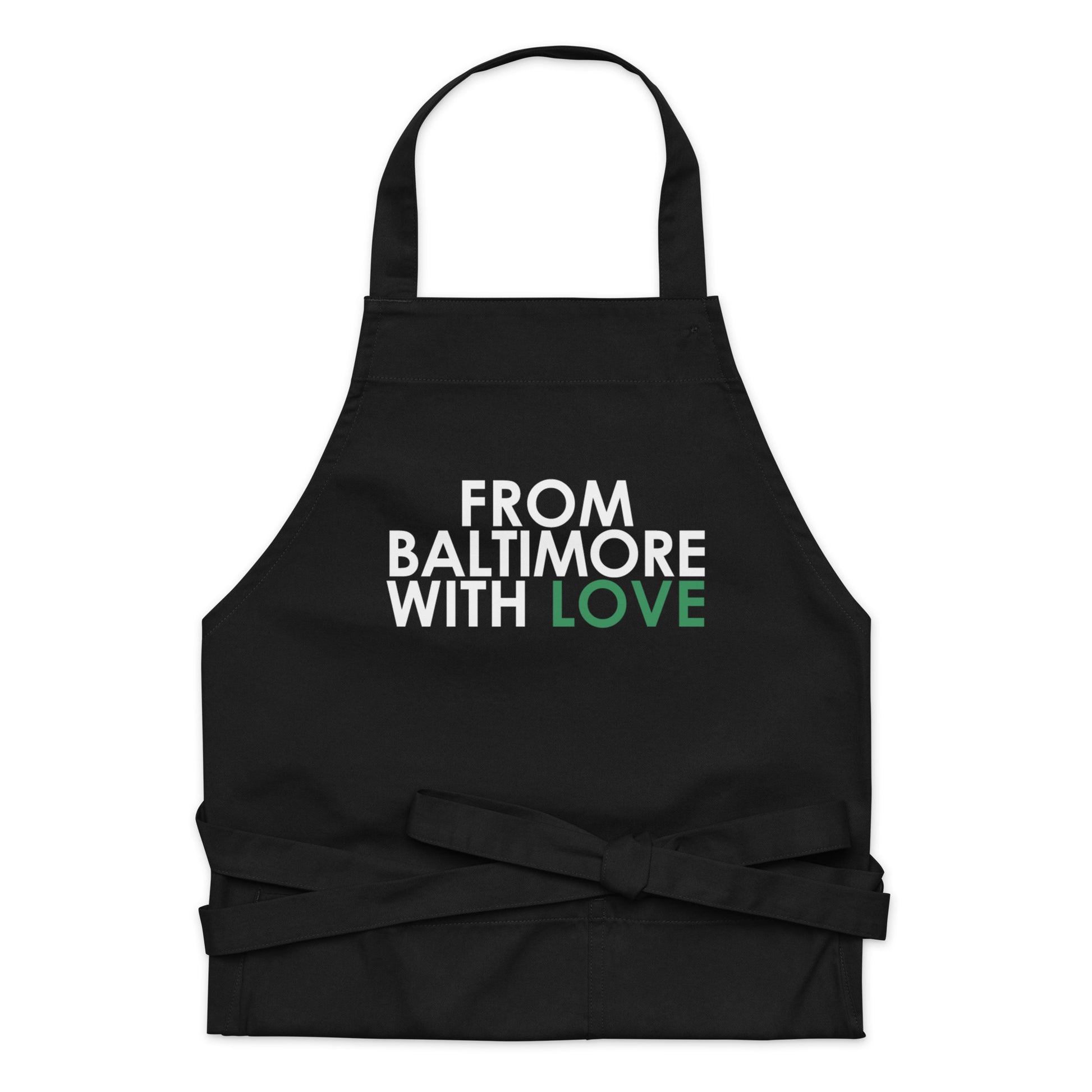 Green cotton apron from Baltimore With Love™ featuring the FBWL logo, shown hanging with adjustable neck strap.
