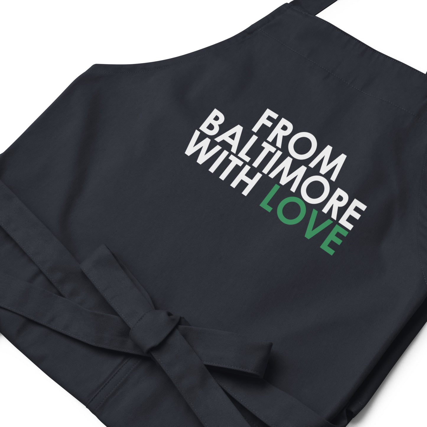 Green cotton apron from From Baltimore With Love™ featuring a classic design, perfect for cooking or gardening.