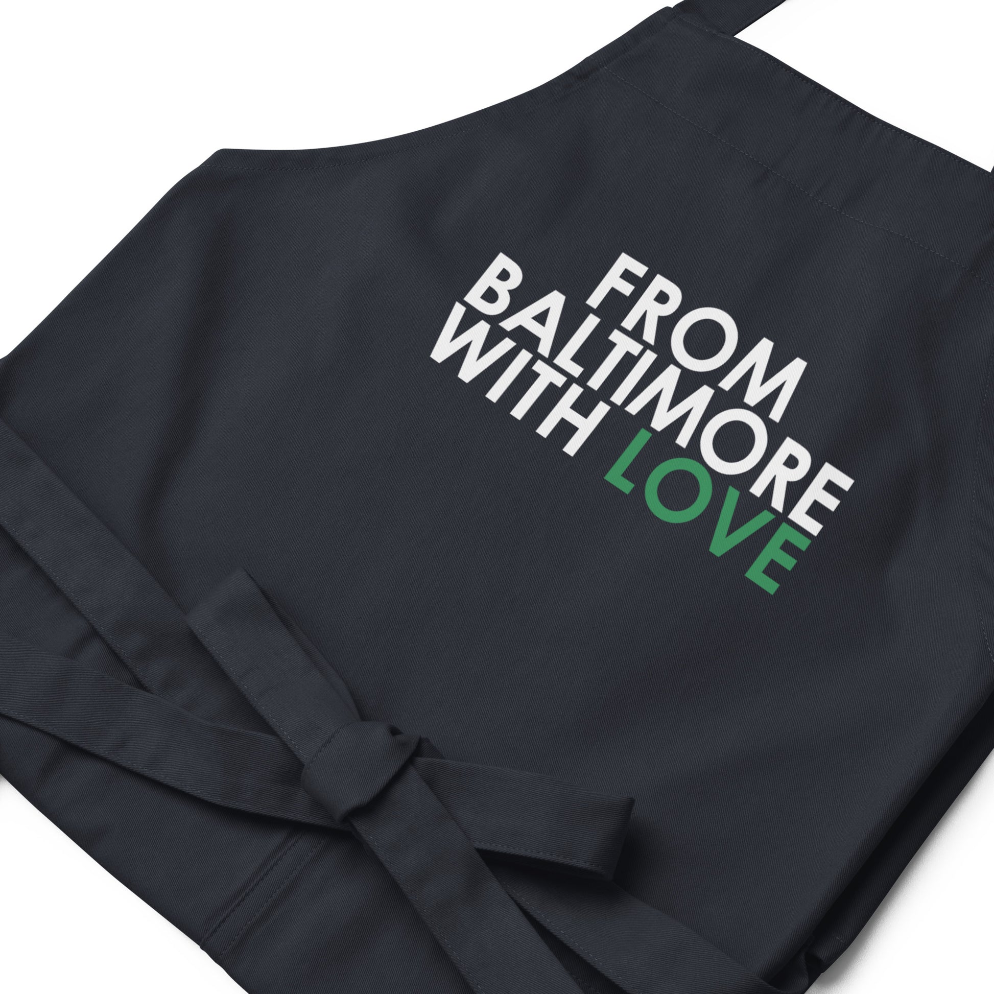 Green cotton apron from From Baltimore With Love™ featuring a classic design, perfect for cooking or gardening.