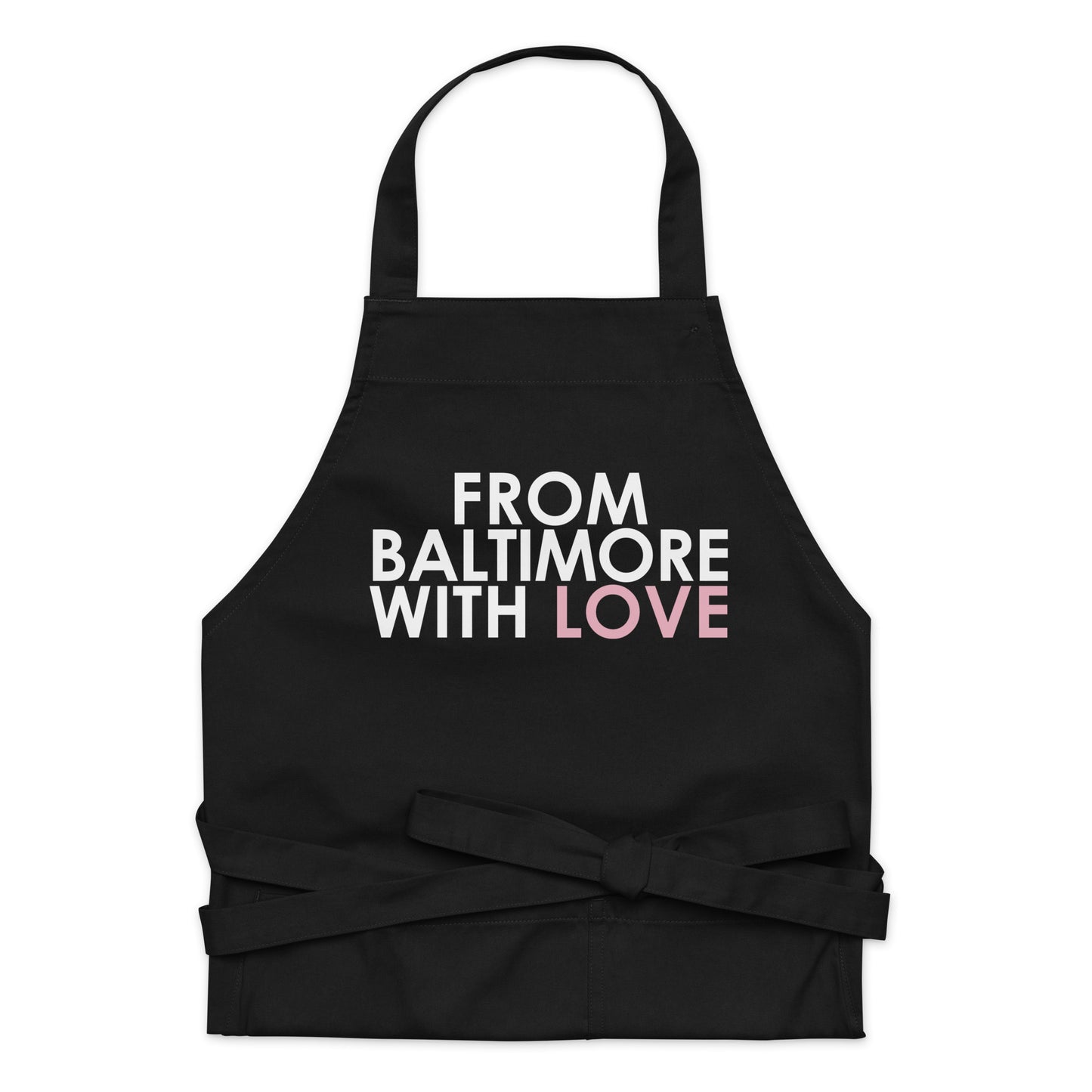 Pink cotton apron by From Baltimore With Love™ with adjustable neck strap and front pockets, ideal for cooking or baking.