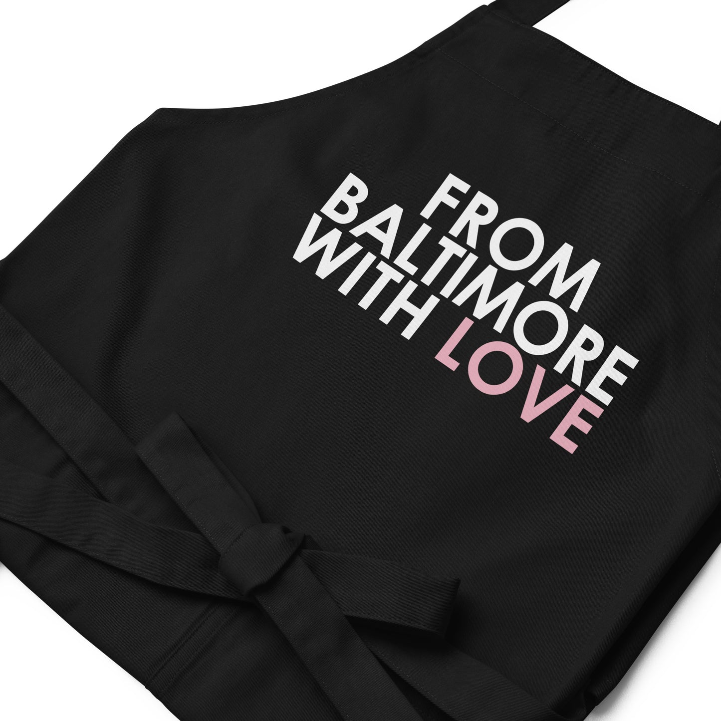 Pink cotton apron from From Baltimore With Love™ featuring a comfortable fit and stylish design for cooking or crafting.
