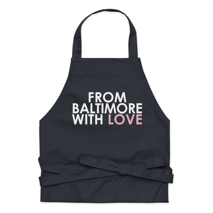 Pink cotton apron by From Baltimore With Love™ featuring a comfortable fit and practical design for cooking or baking.