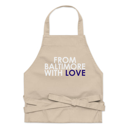 Purple cotton apron from From Baltimore With Love™ with adjustable neck strap and front pockets for cooking or baking.
