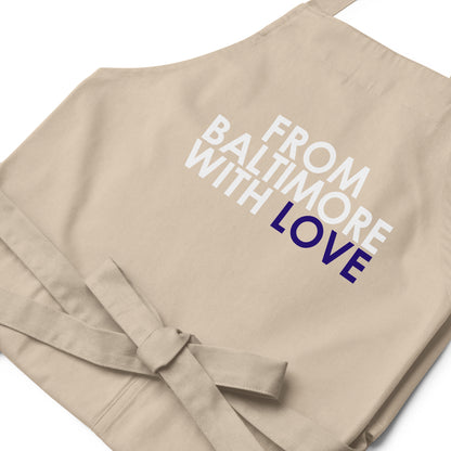 Purple cotton apron from From Baltimore With Love™ with adjustable neck strap and front pockets, designed for cooking or crafting.