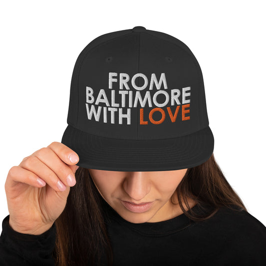 Black and orange Baltimore-inspired snapback hat from From Baltimore With Love™ featuring a classic adjustable design.